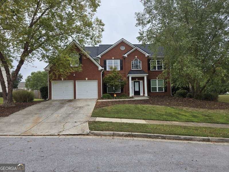 a front view of a house with a yard