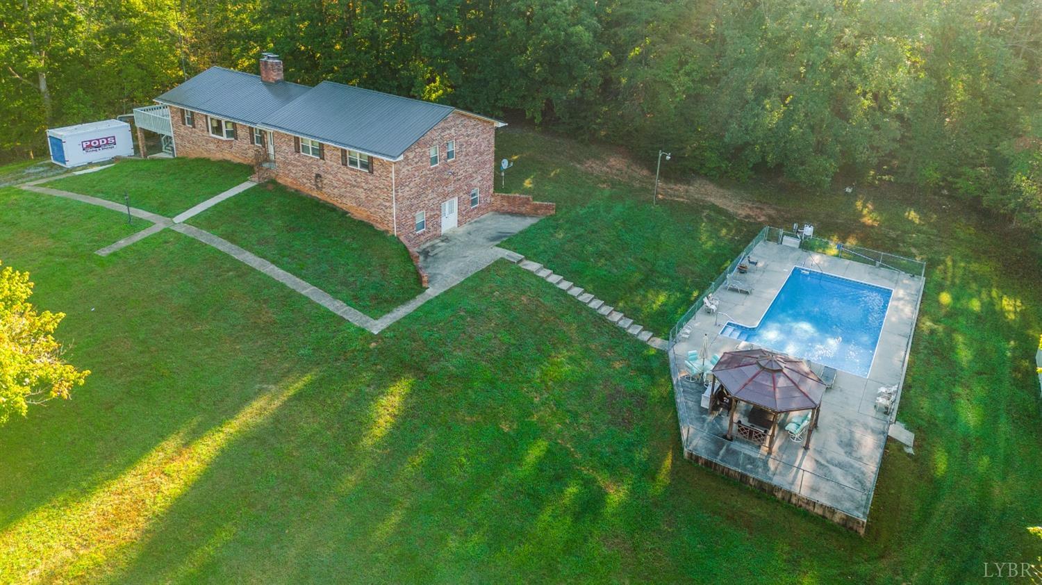 an aerial view of a house with a yard table and chairs