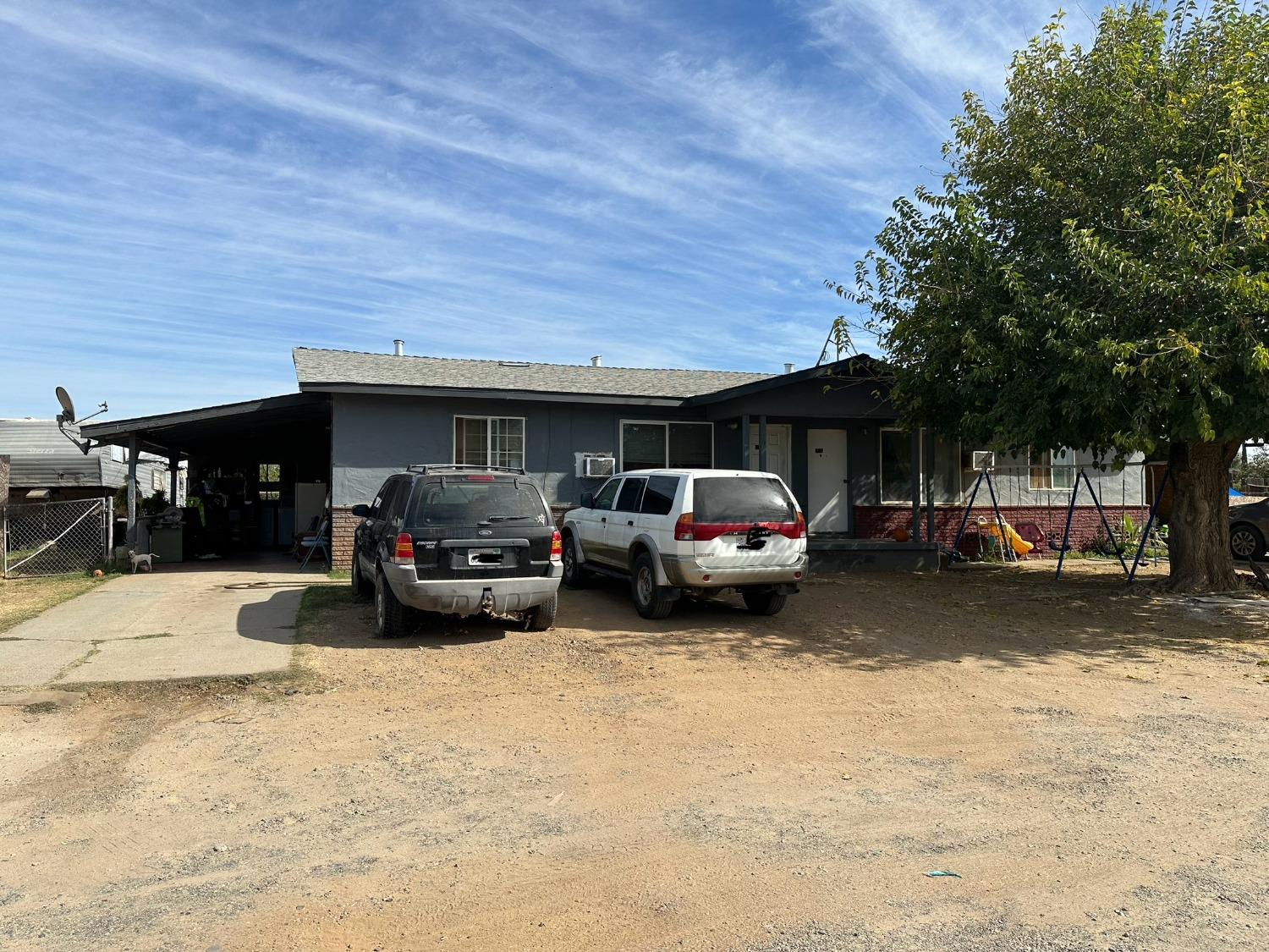 a view of a cars park in front of a house