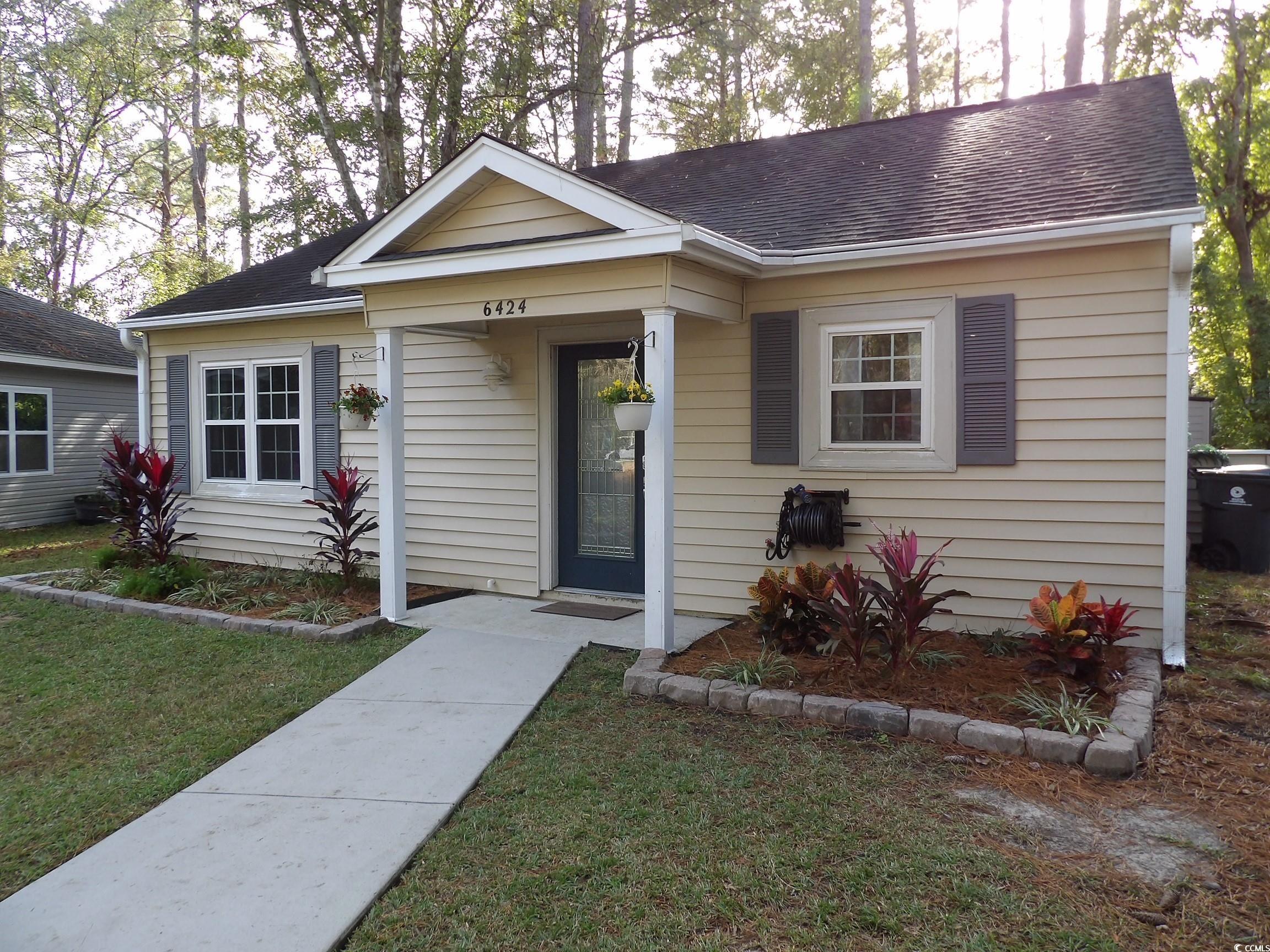 Bungalow-style house with a front yard