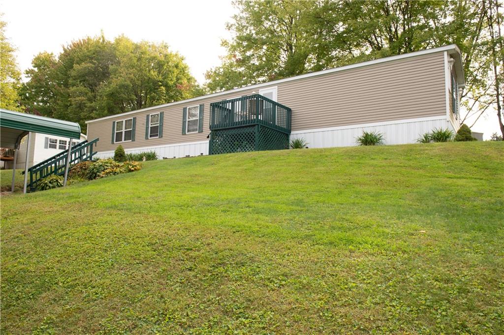 a front view of house with yard and trees