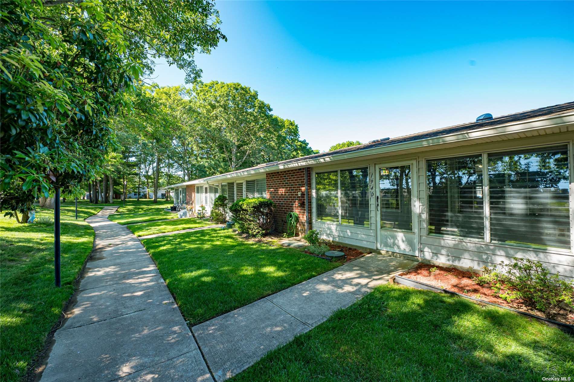 a view of a house with a yard and sitting area