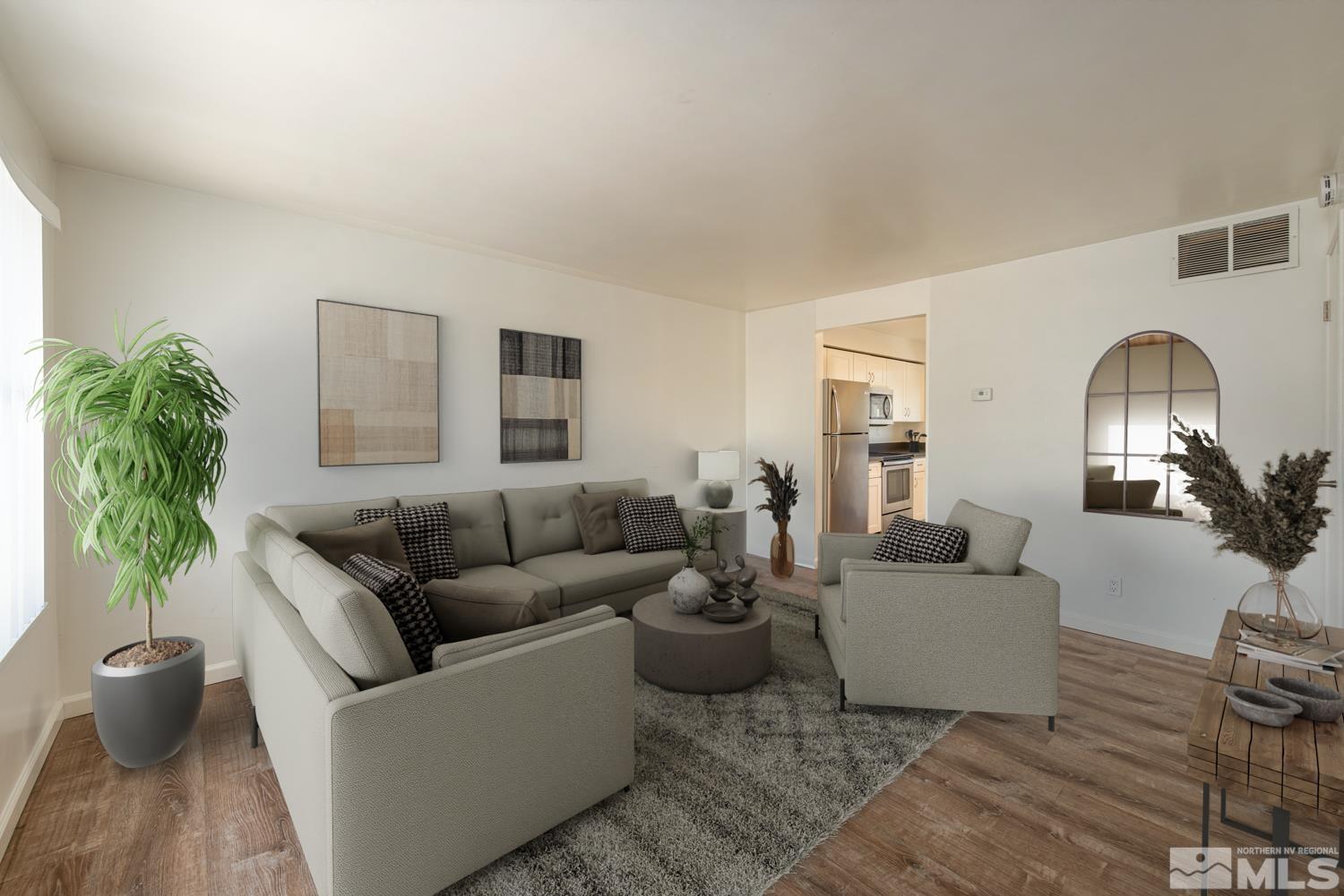 a living room with furniture and a potted plant