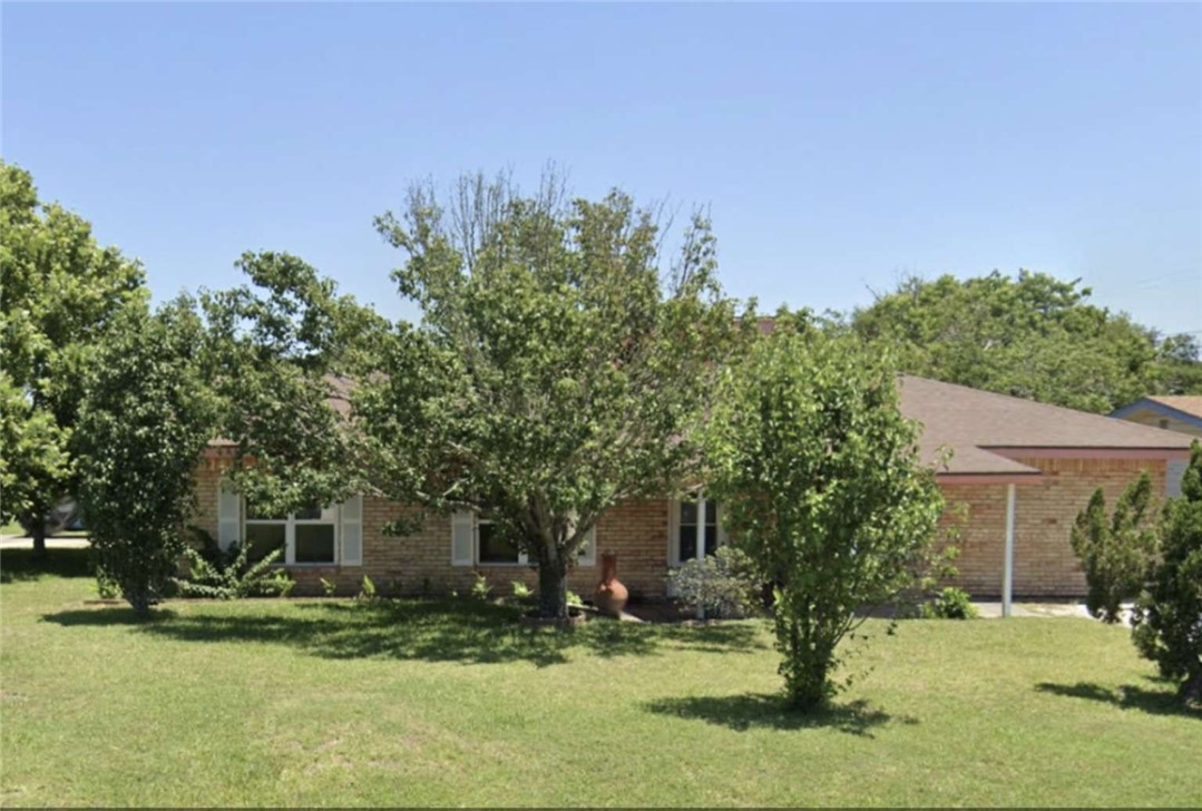 a front view of a house with a yard garage and outdoor seating