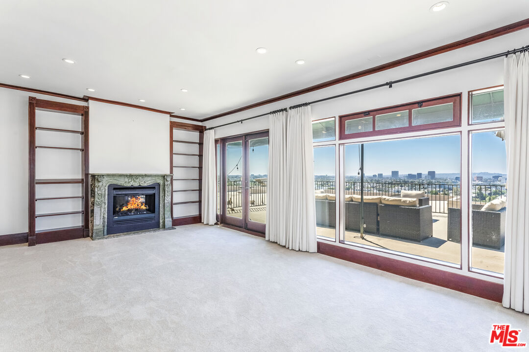 an empty room with a fireplace and window