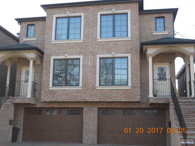 a front view of brick house with large windows