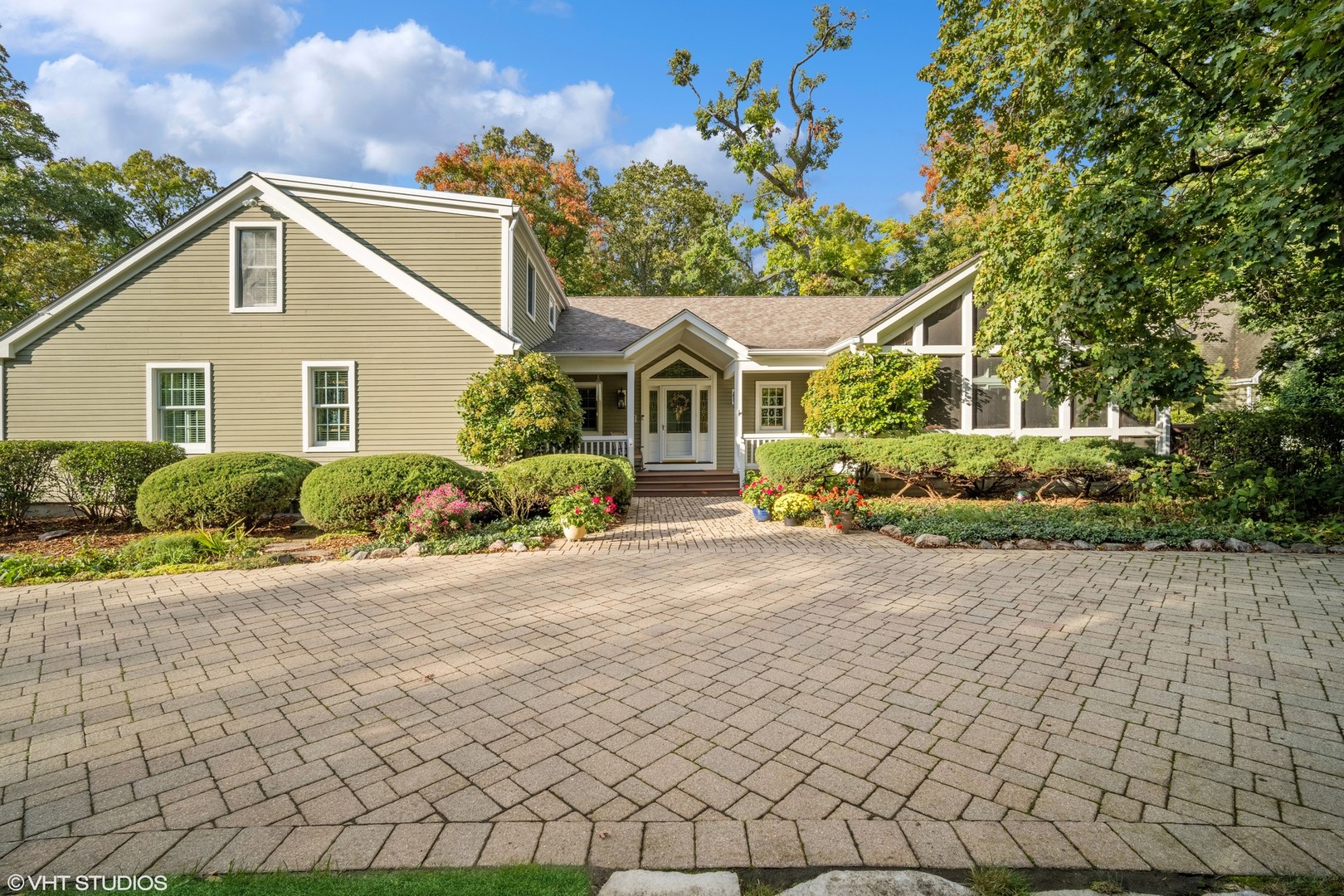 a front view of a house with a garden