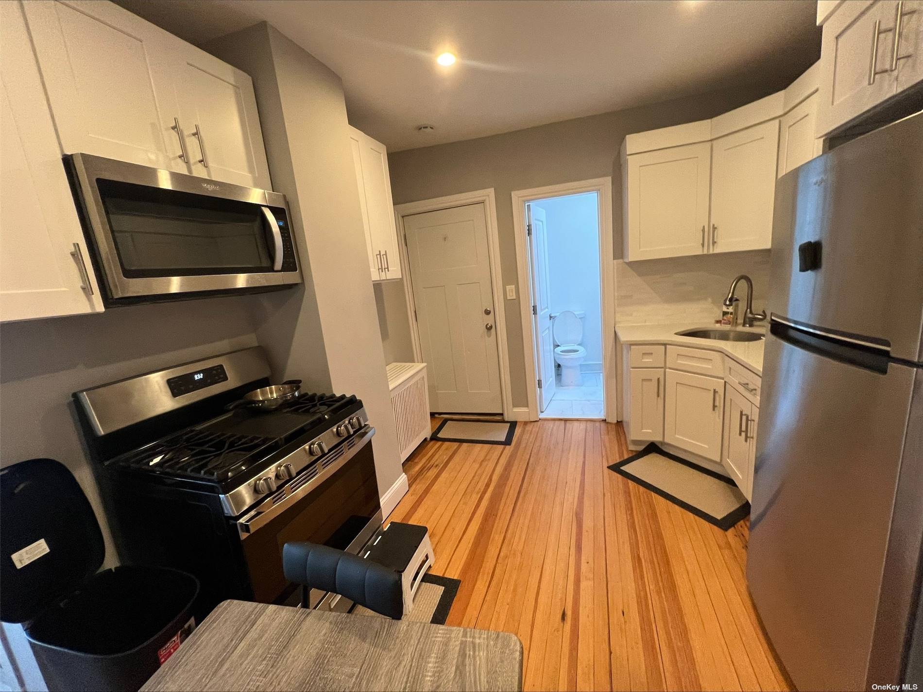 a kitchen with stainless steel appliances a microwave a stove and a refrigerator