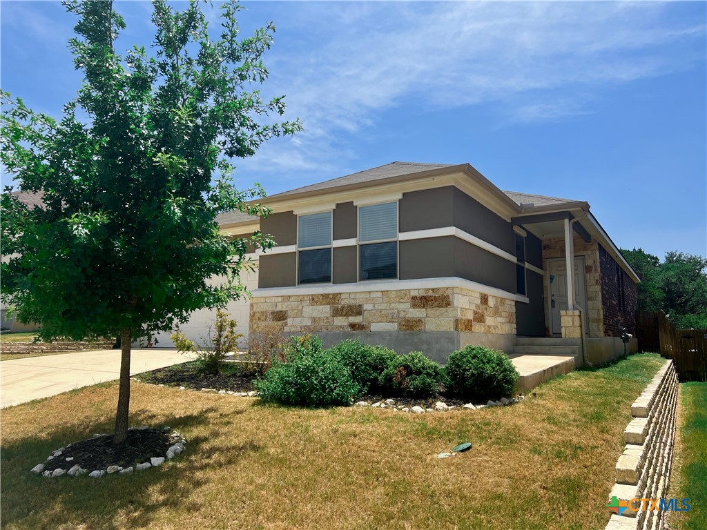 a front view of a house with a yard