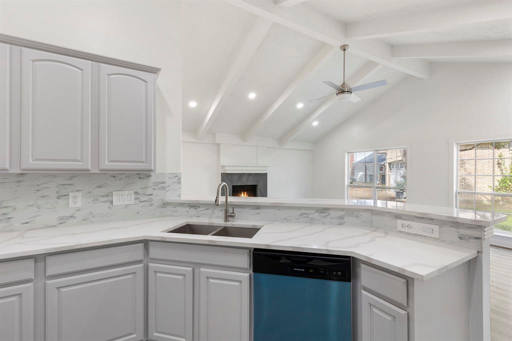 a kitchen with a sink a center island and cabinets