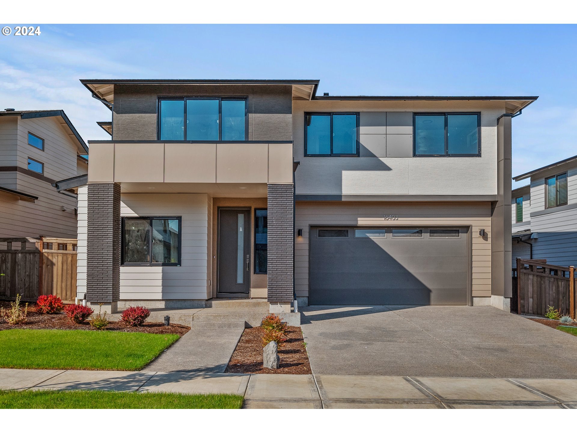 a front view of a house with a yard and garage