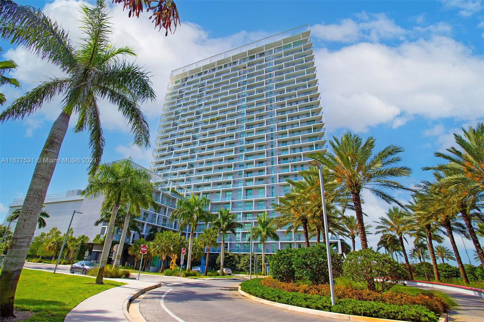 a view of a palm trees in front of a building