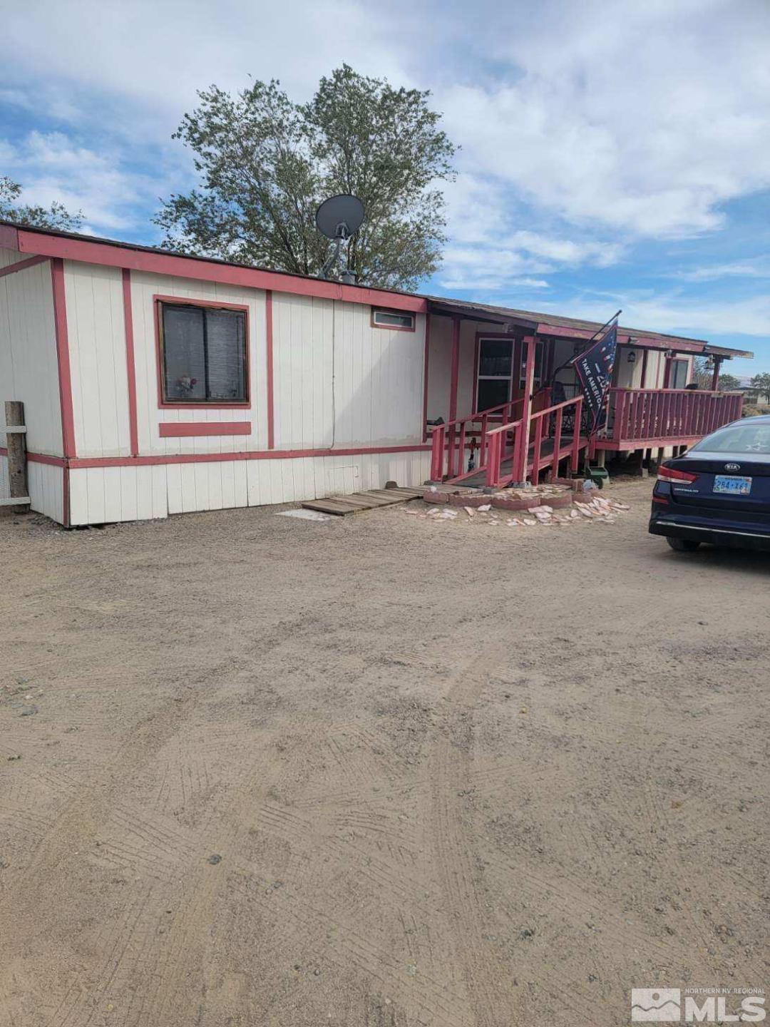 a view of garage with a car parked in it