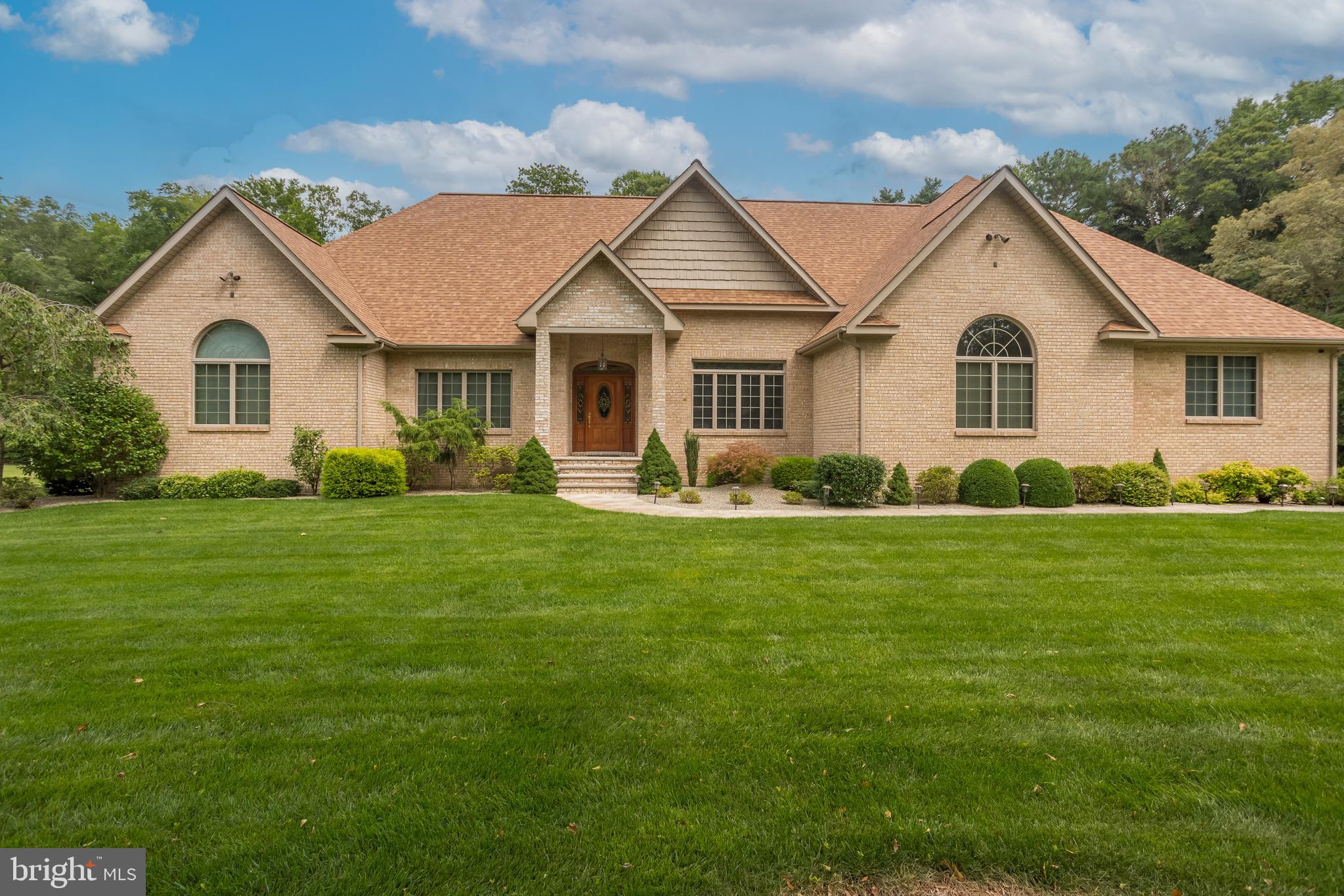 a front view of house with yard and green space