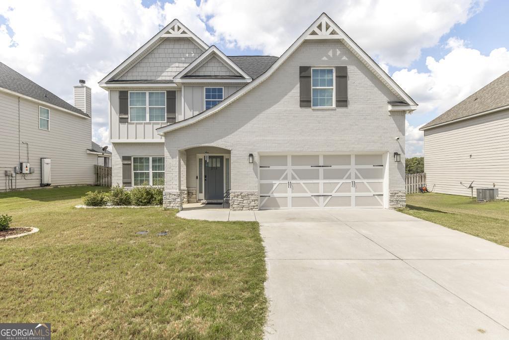 a front view of a house with a yard and garage