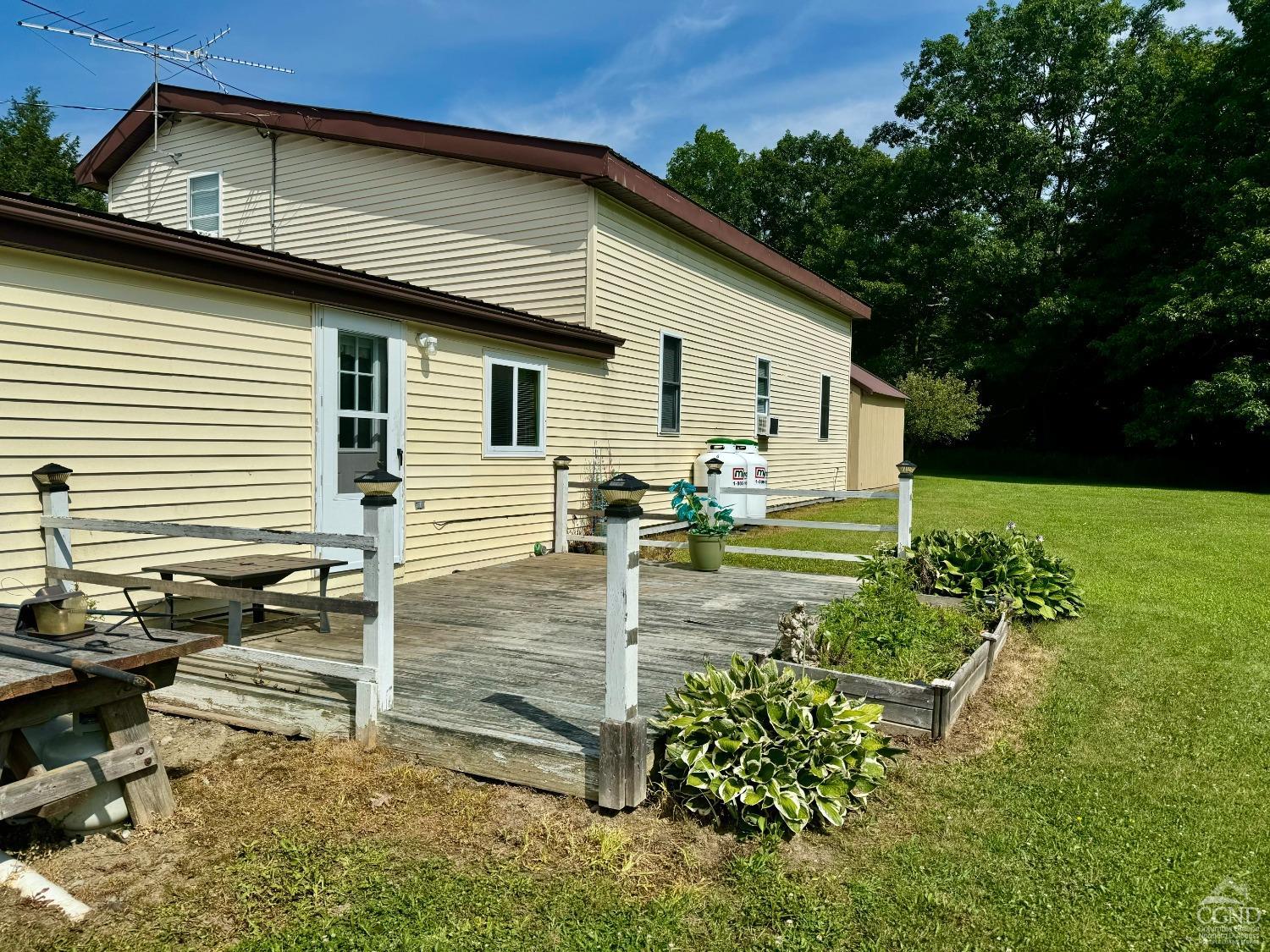 a view of a backyard with sitting area