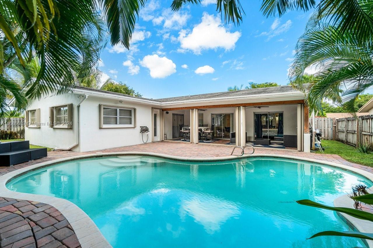 a view of a house with swimming pool having outdoor seating