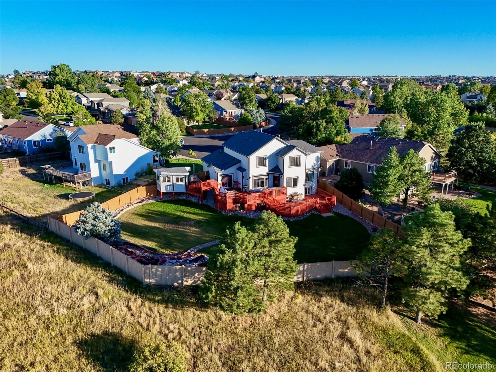 a aerial view of a house with a garden and lake view