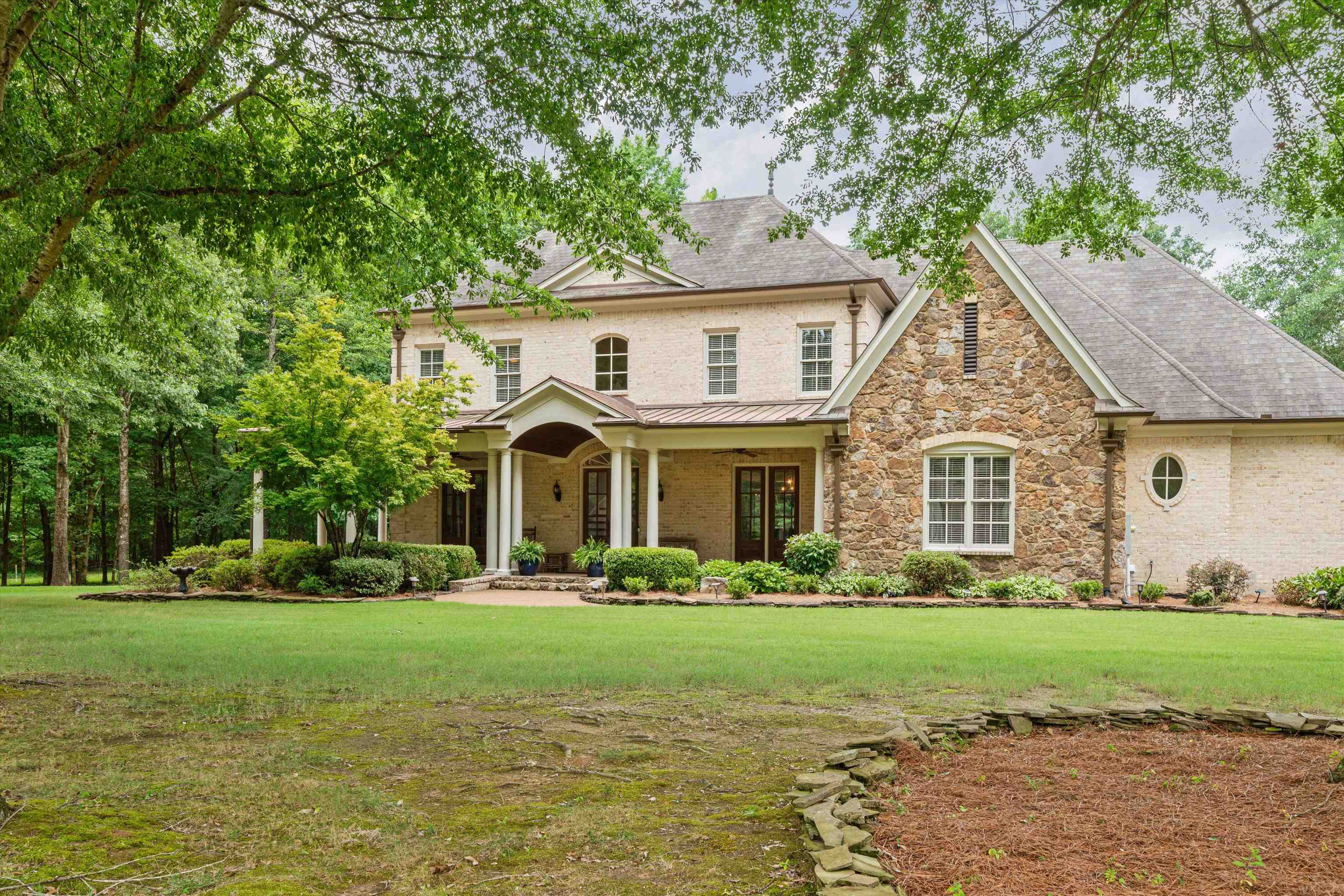 a front view of house with yard and green space