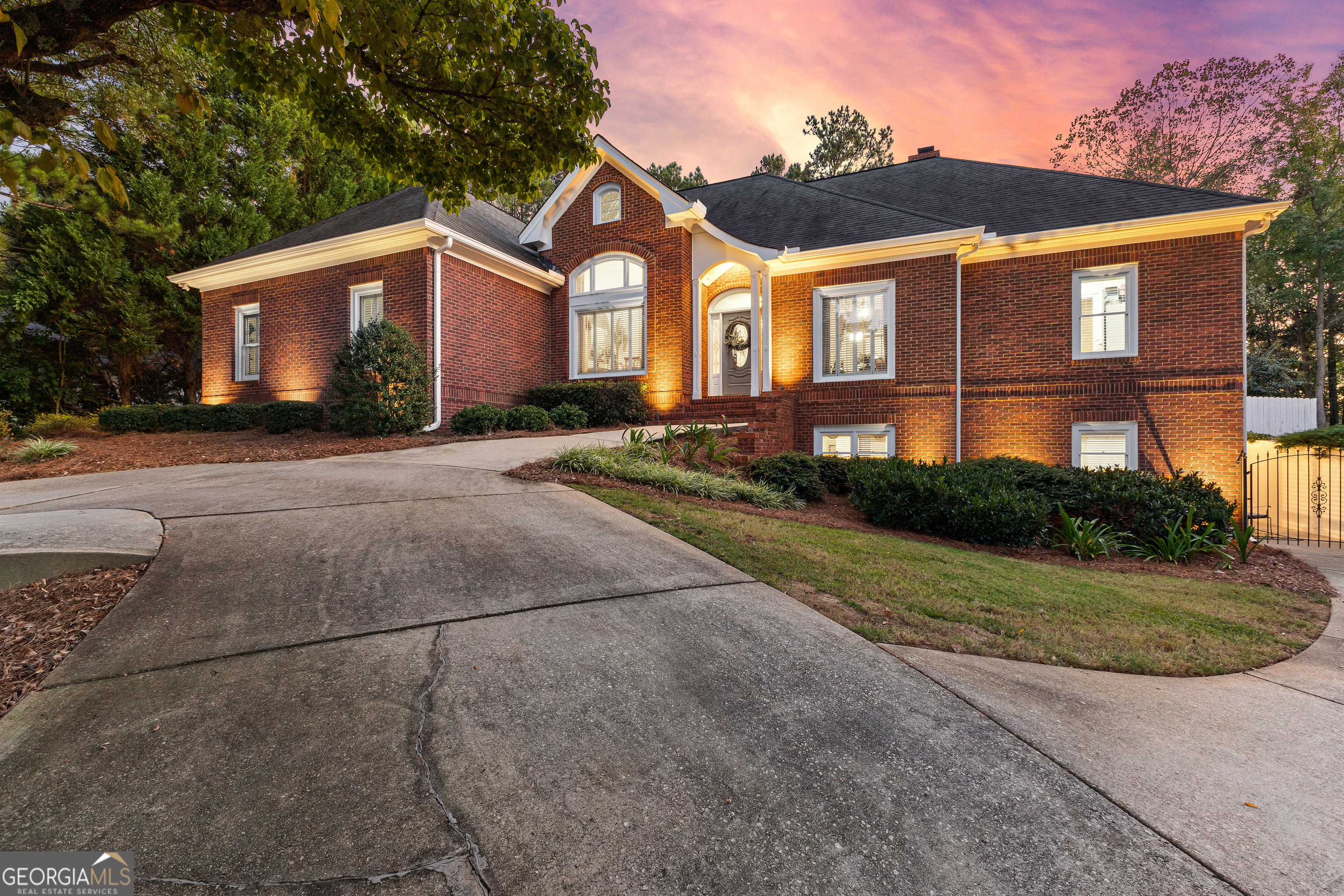 a front view of a house with a yard and a garage