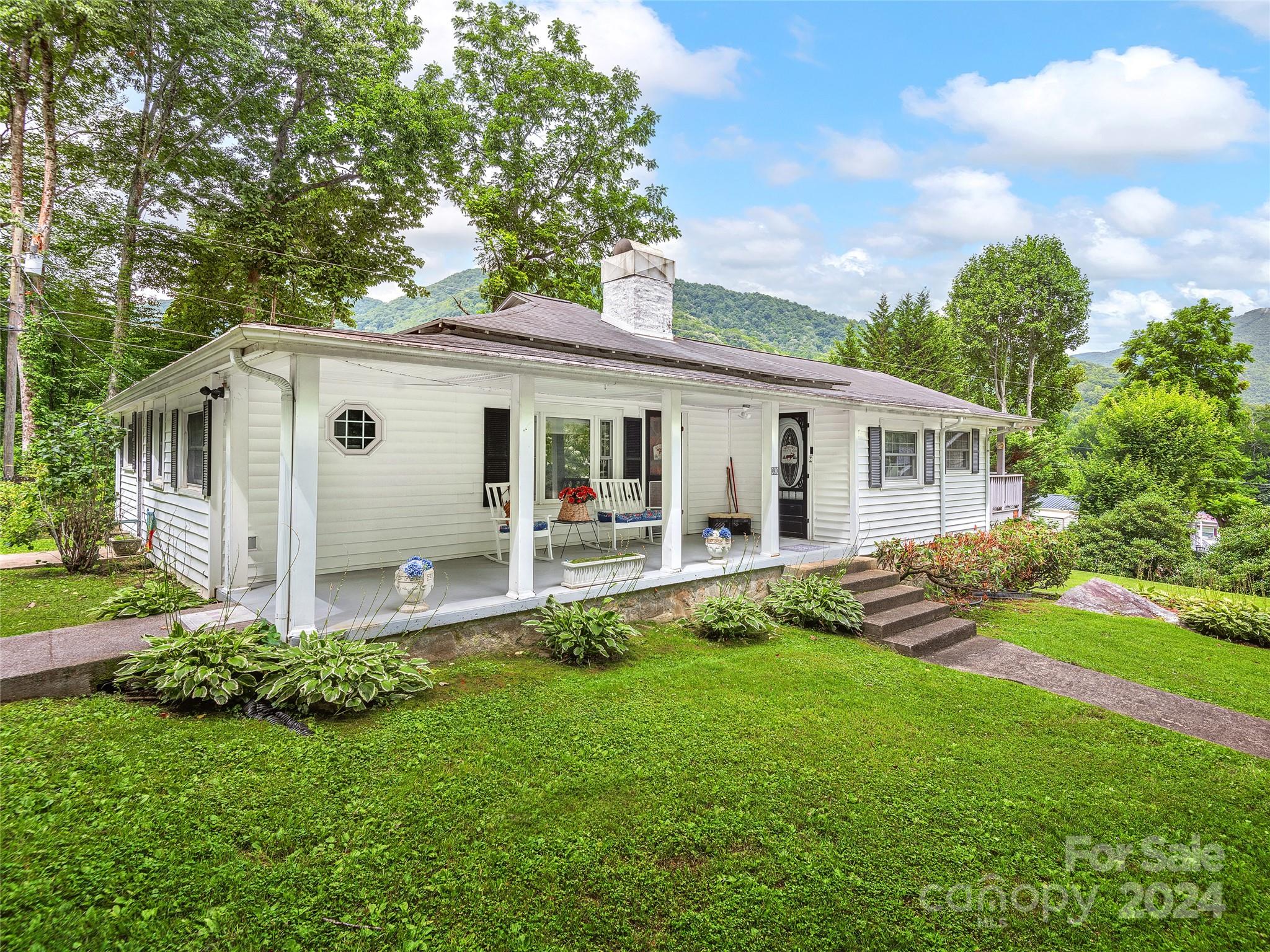 a front view of house with yard and green space