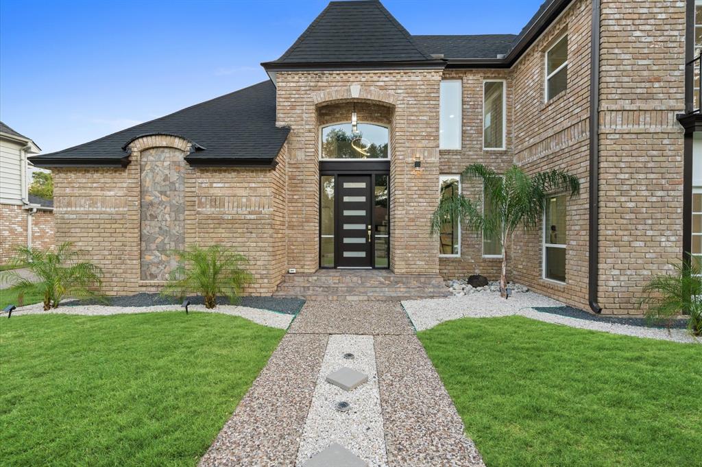 a front view of a house with garden