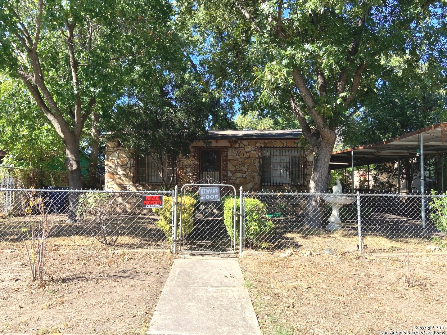 a view of backyard with plants and outdoor seating