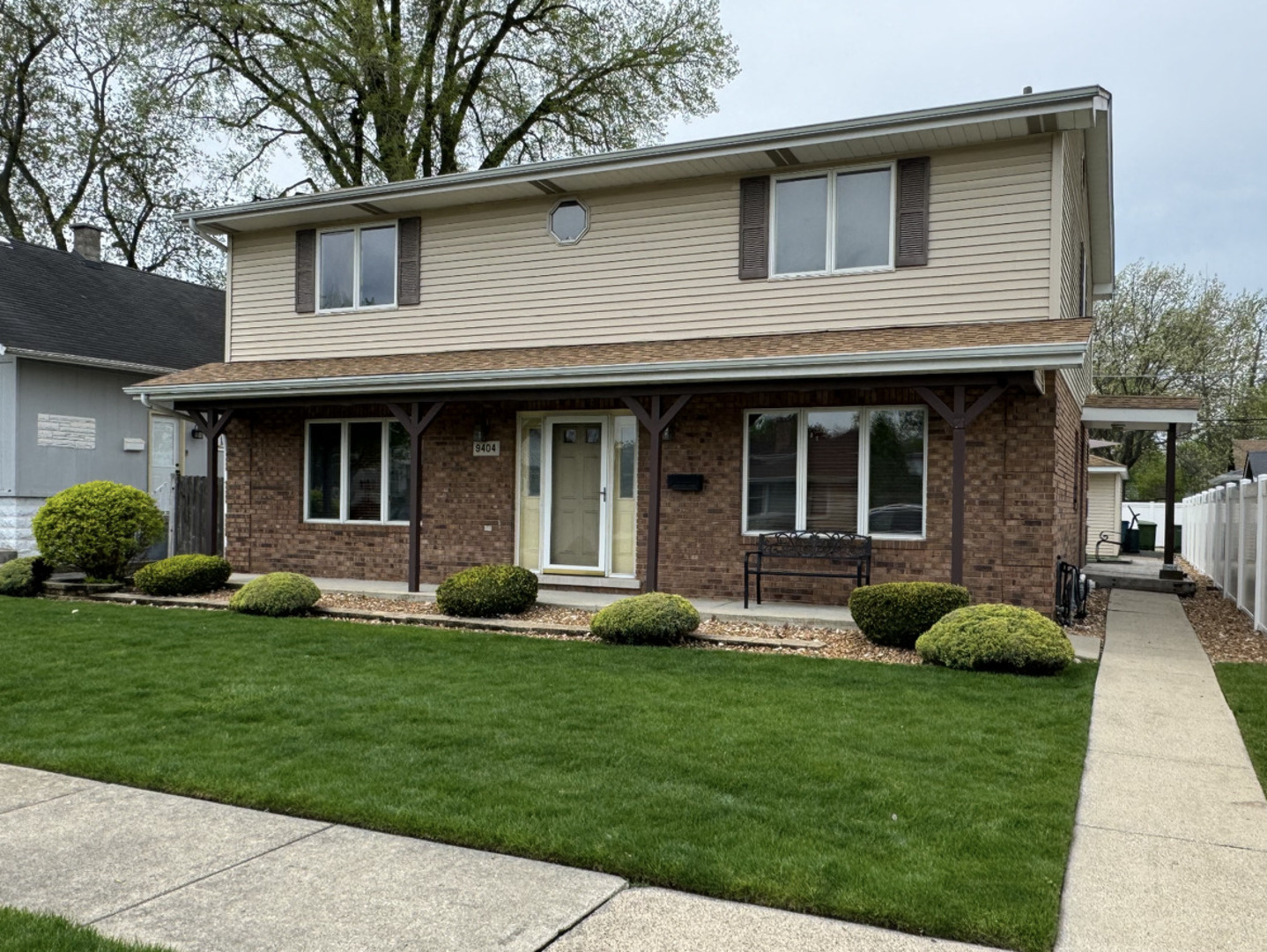 a view of a house with a yard and plants with large window