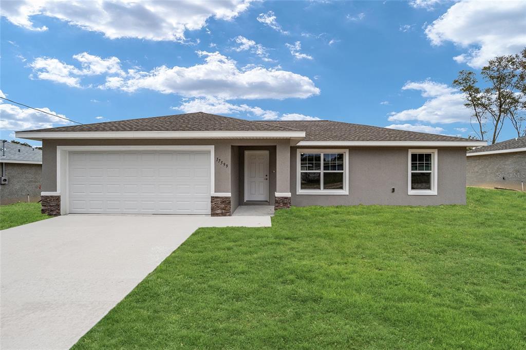 a front view of house with yard and green space