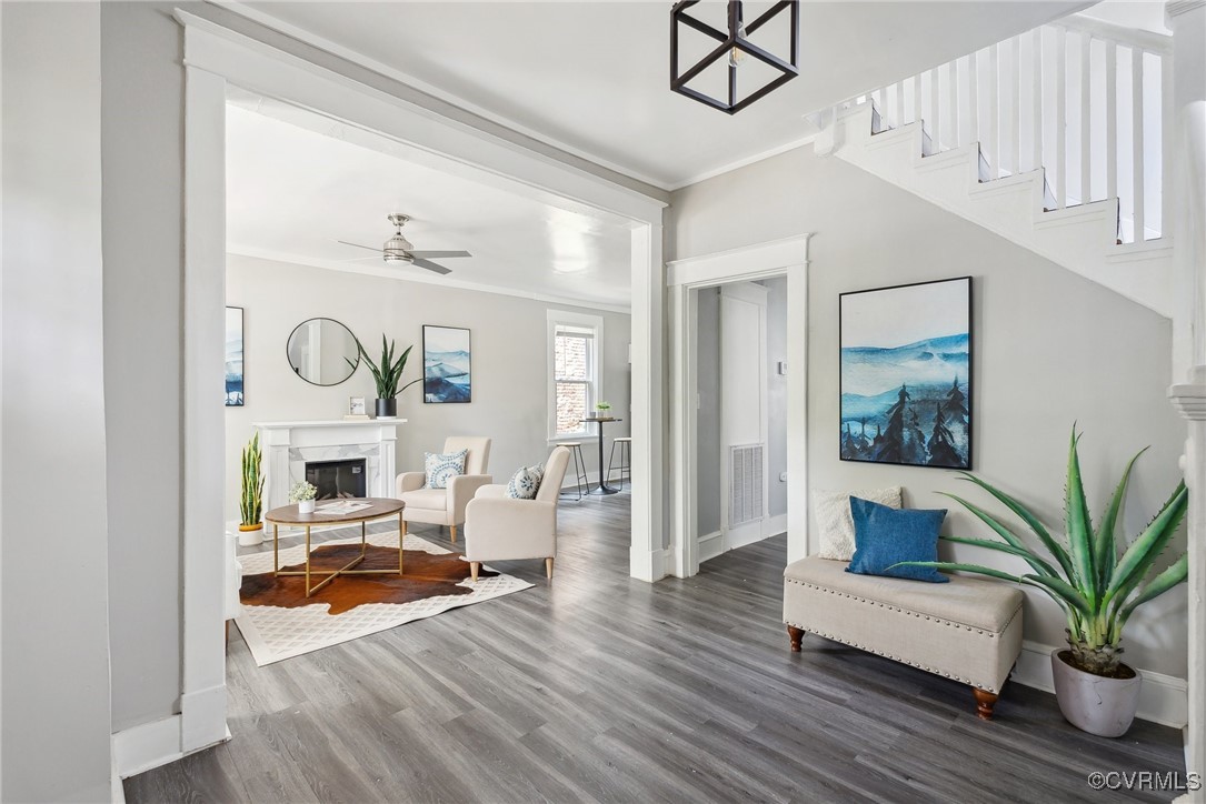 Living room with crown molding, dark hardwood / wo