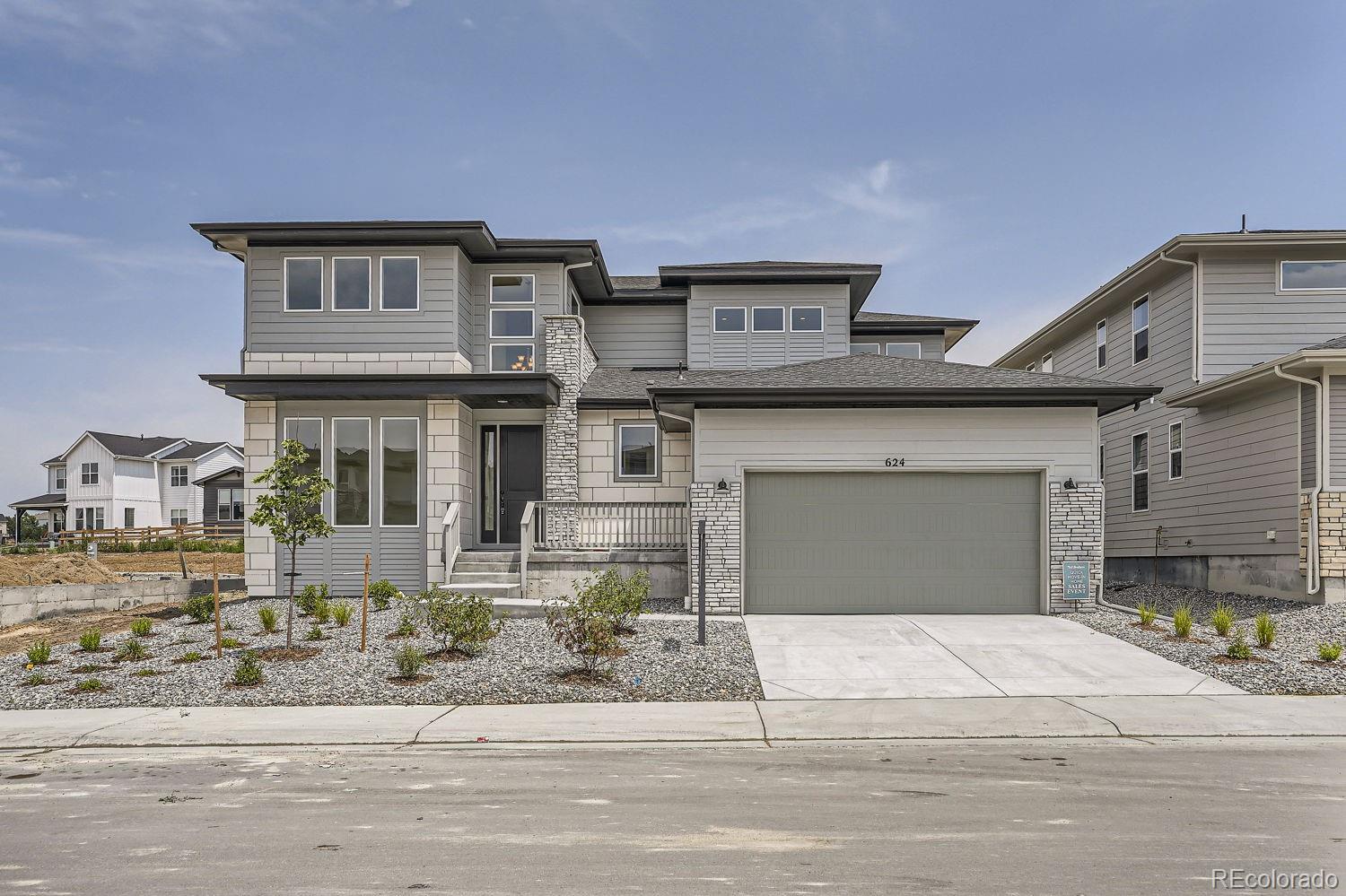 a front view of a house with a yard and garage