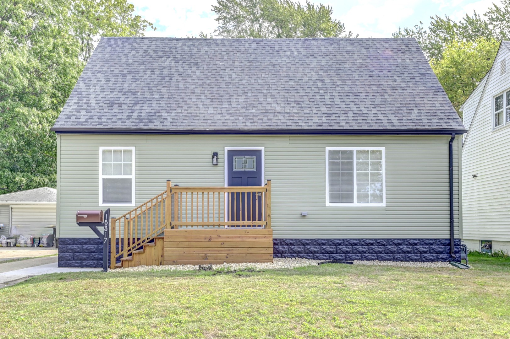 a front view of a house with a garden