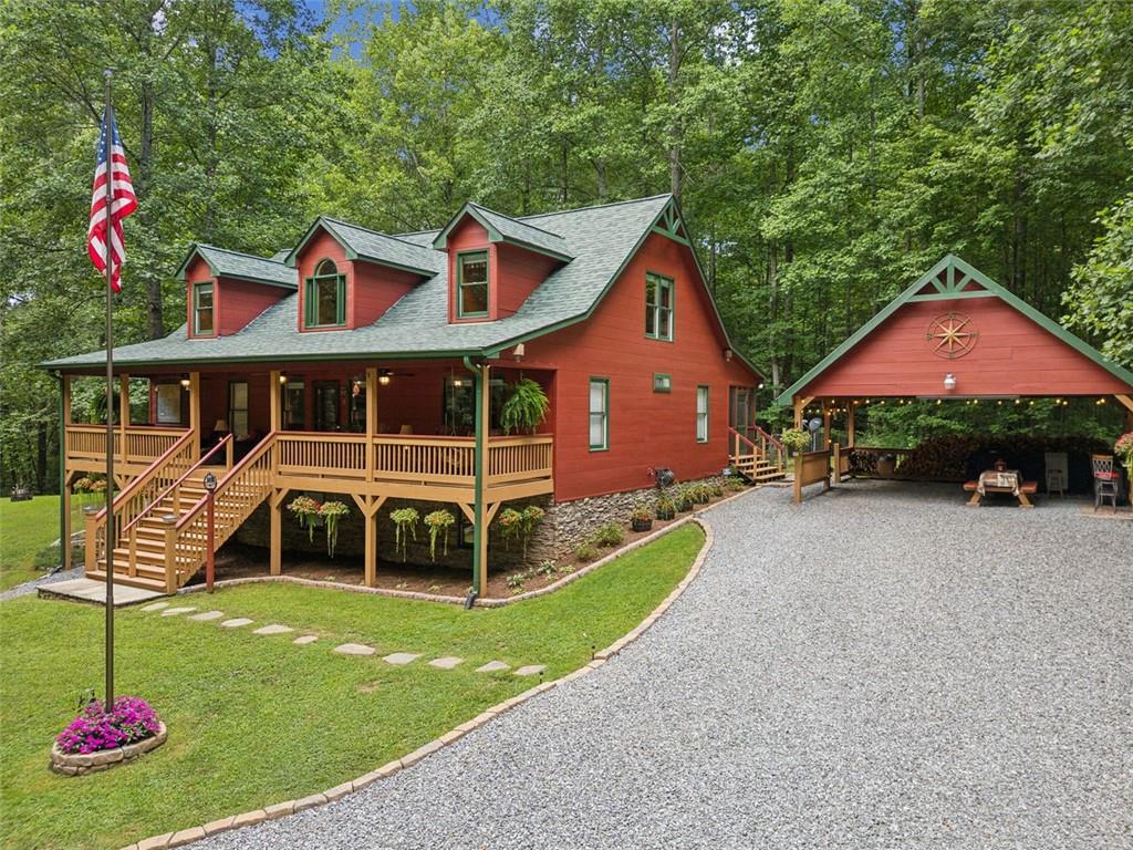 a front view of a house with a garden and deck