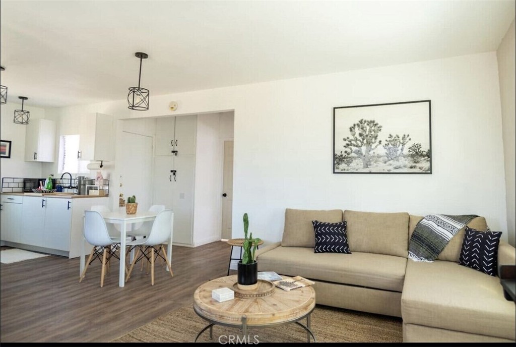 a living room with furniture and a dining table