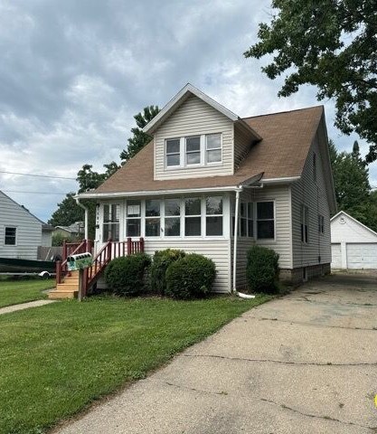 a front view of a house with a yard and trees