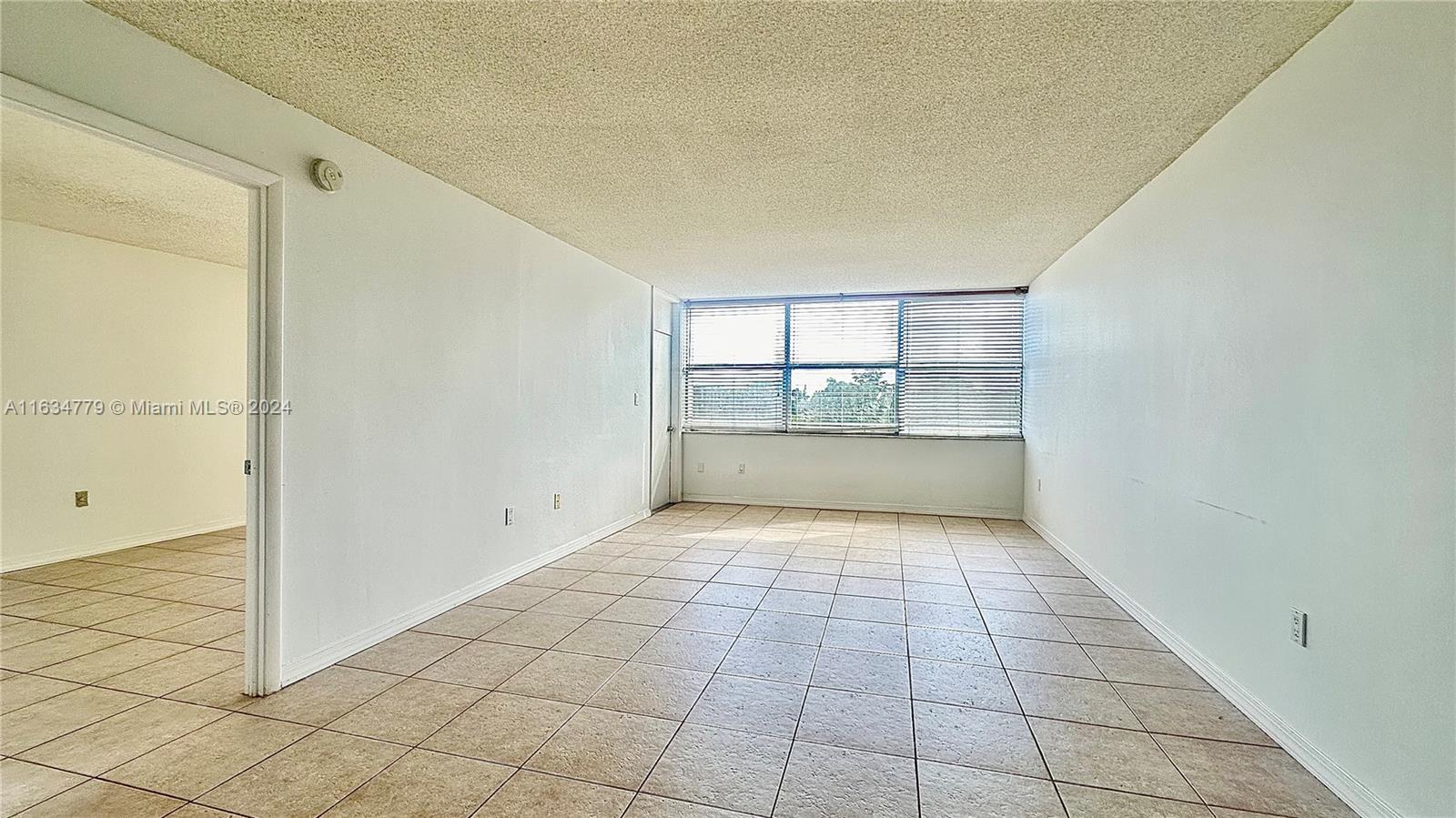 a view of an empty room and a window