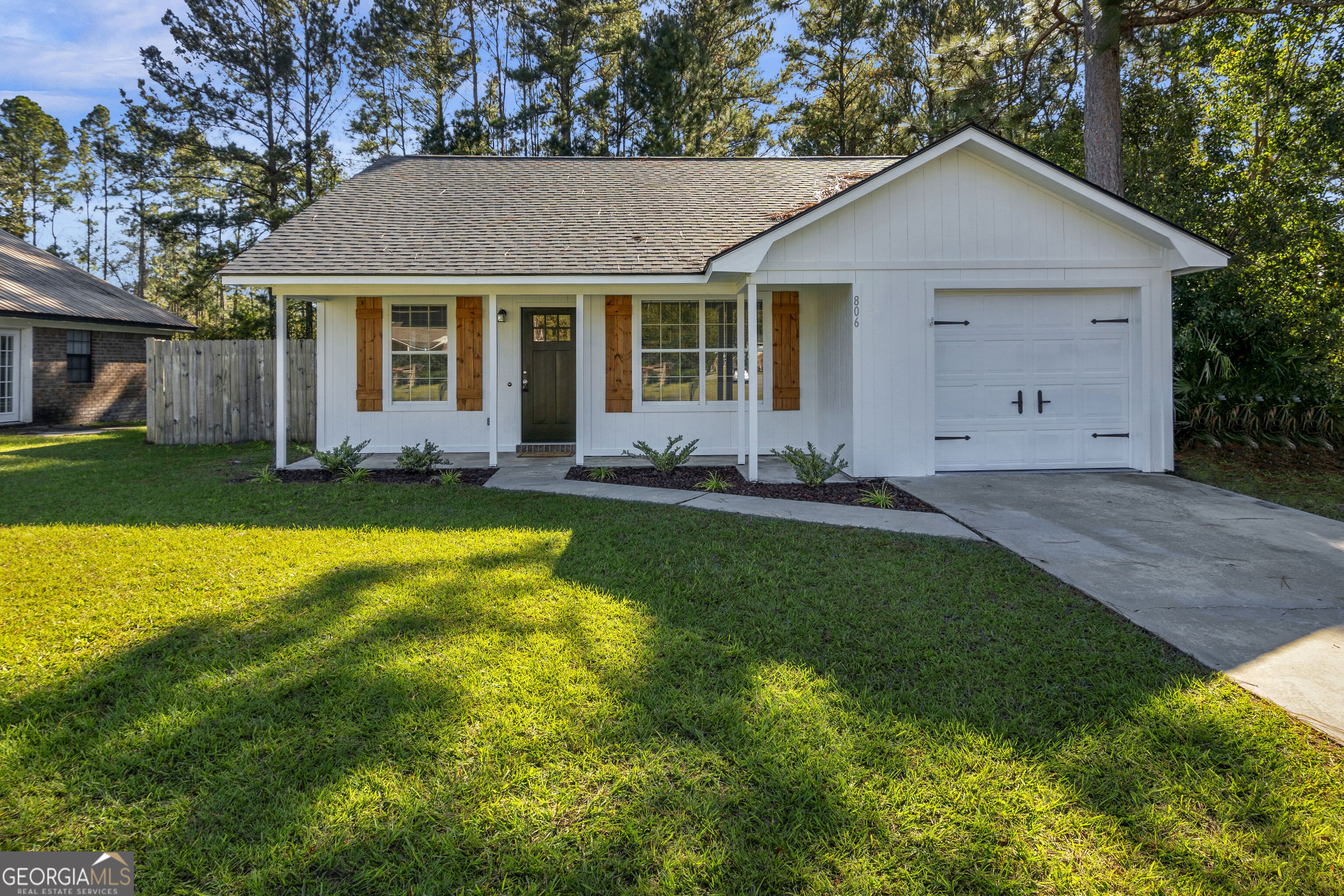 a front view of a house with a yard and porch