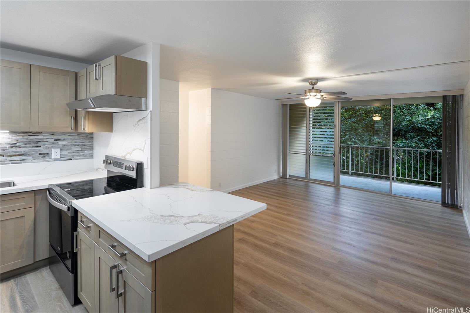 a kitchen that has a lot of cabinets a sink and wooden floor