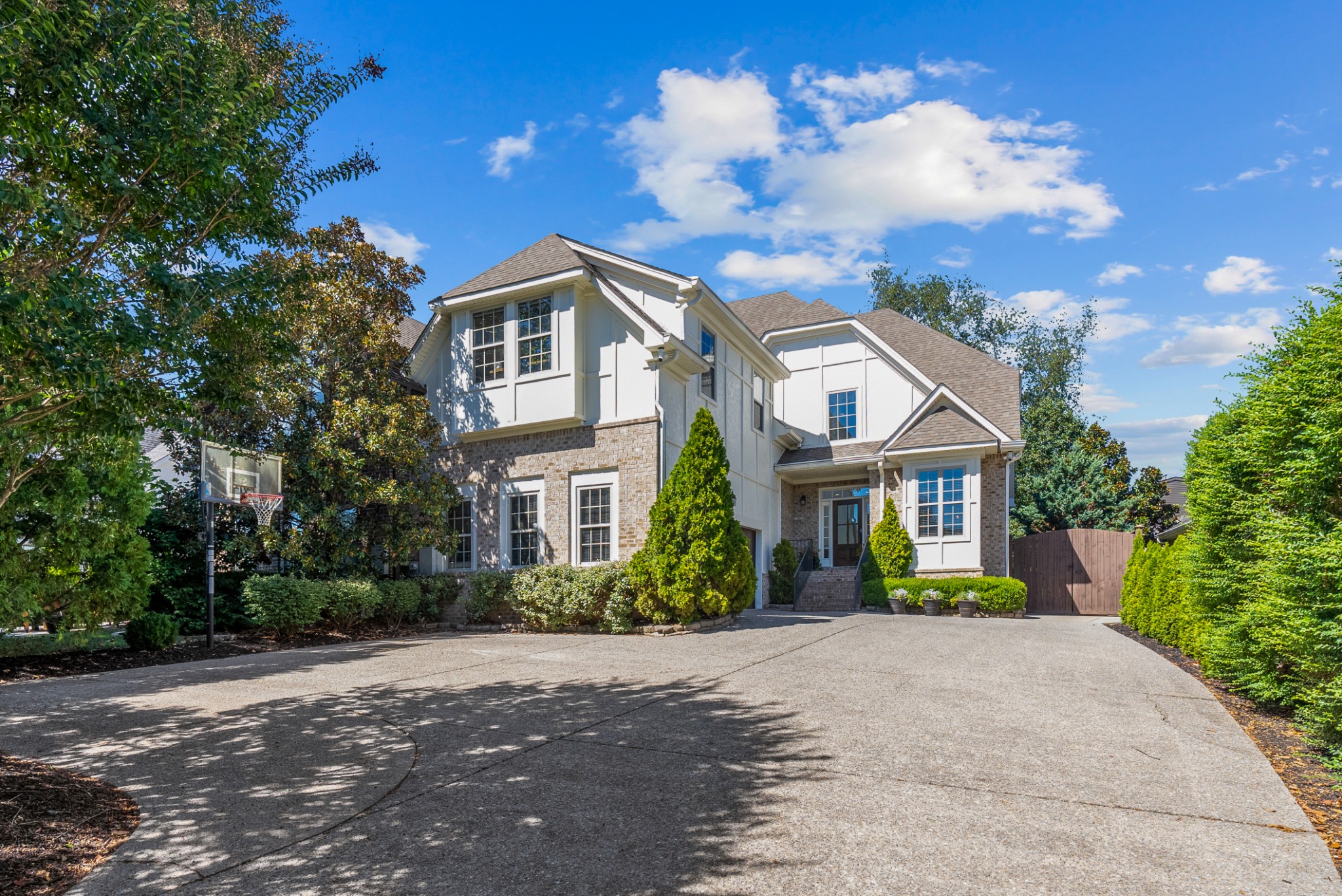 a front view of a house with a garden