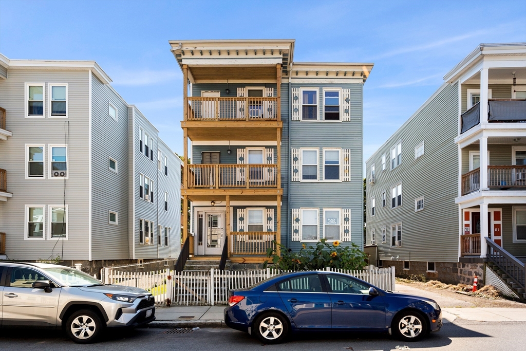 a front view of a house with parking space