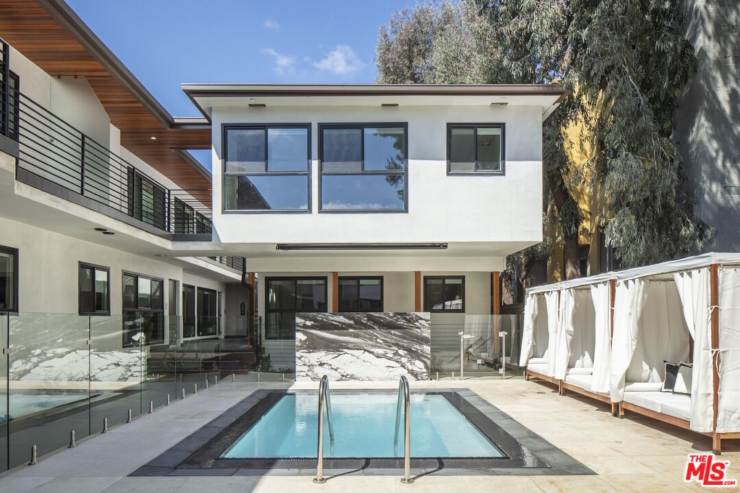 a view of house with swimming pool outdoor seating