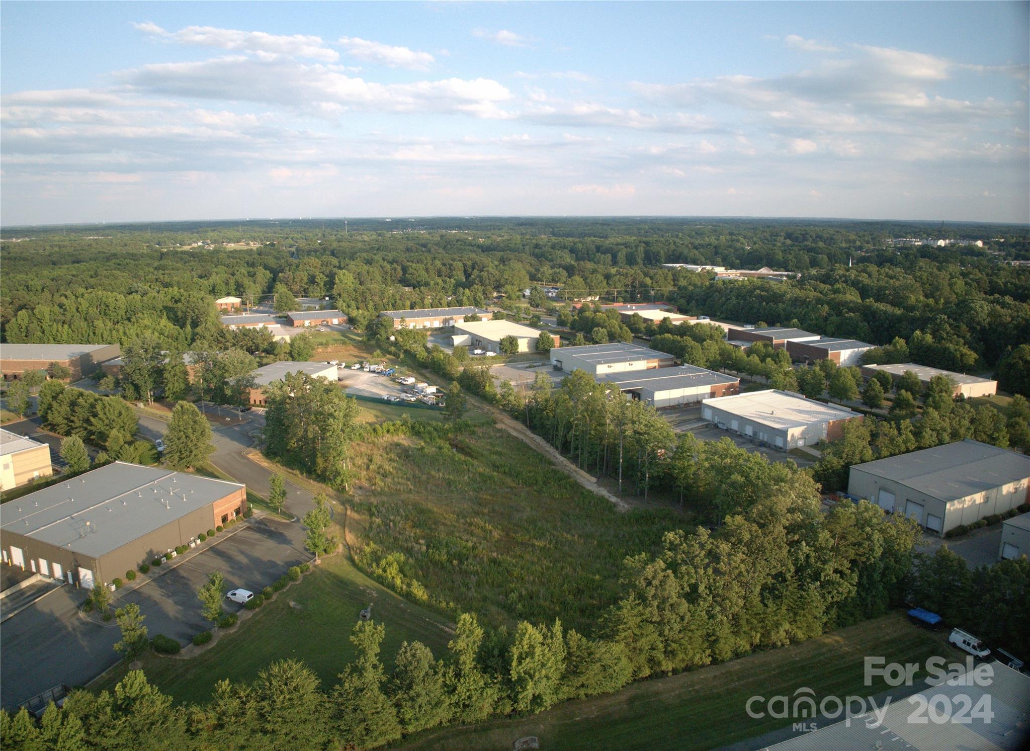 an aerial view of residential house with outdoor space and trees