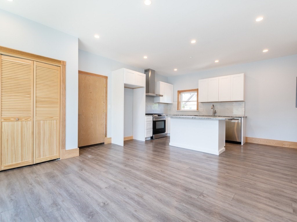 a view of kitchen view wooden floor and window