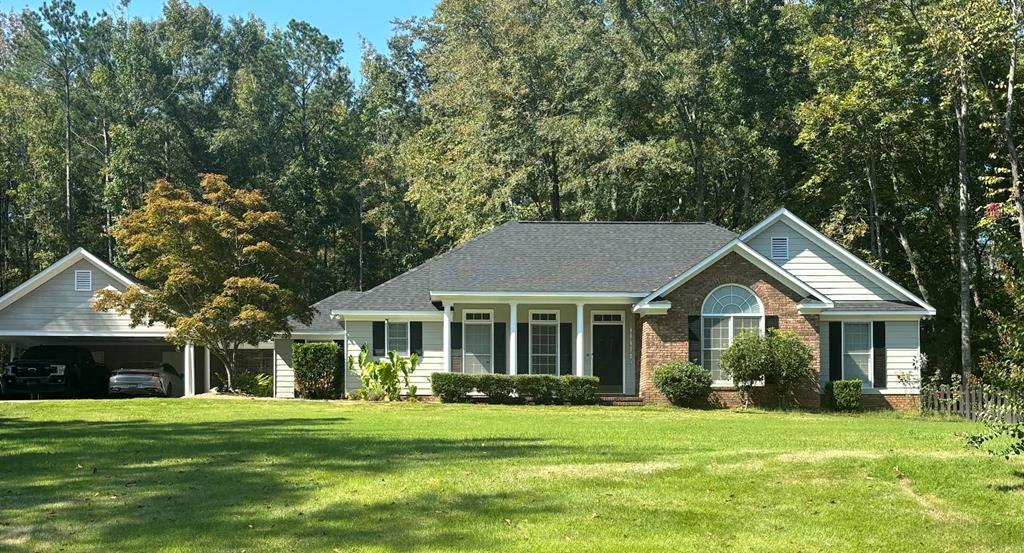 a front view of a house with a garden