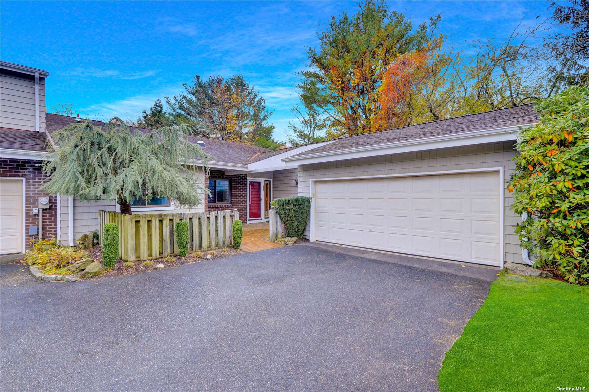 a view of a house with a yard and potted plants