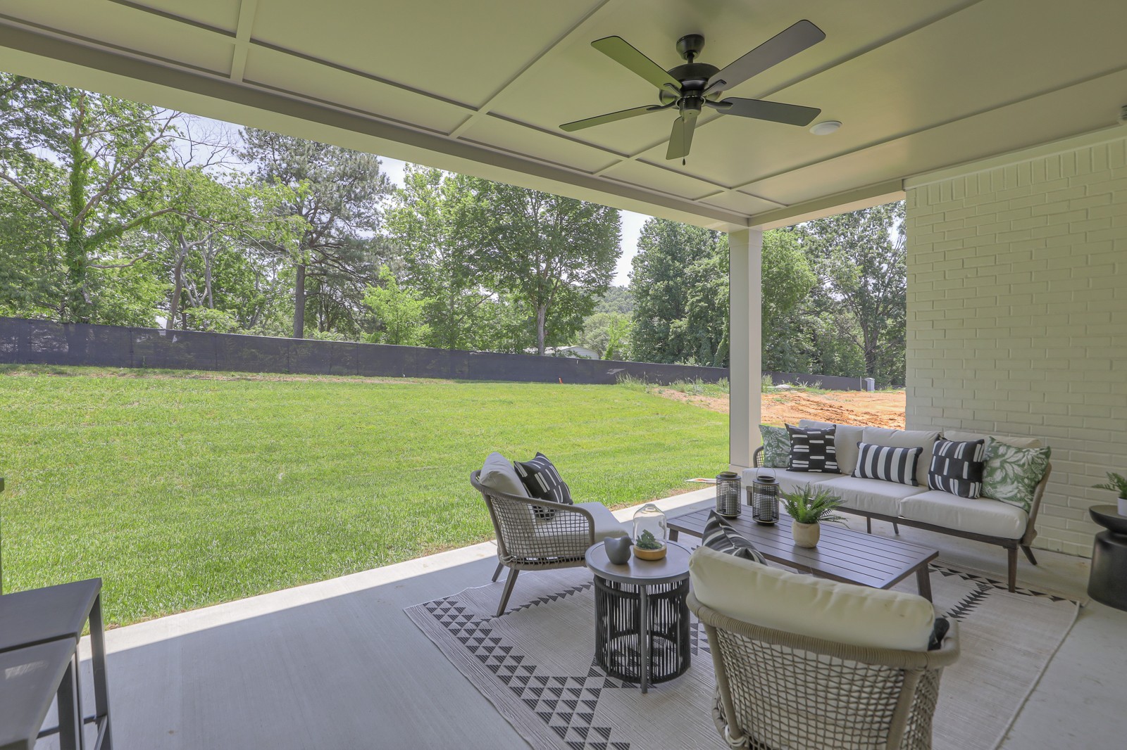 a view of a patio with furniture and a yard