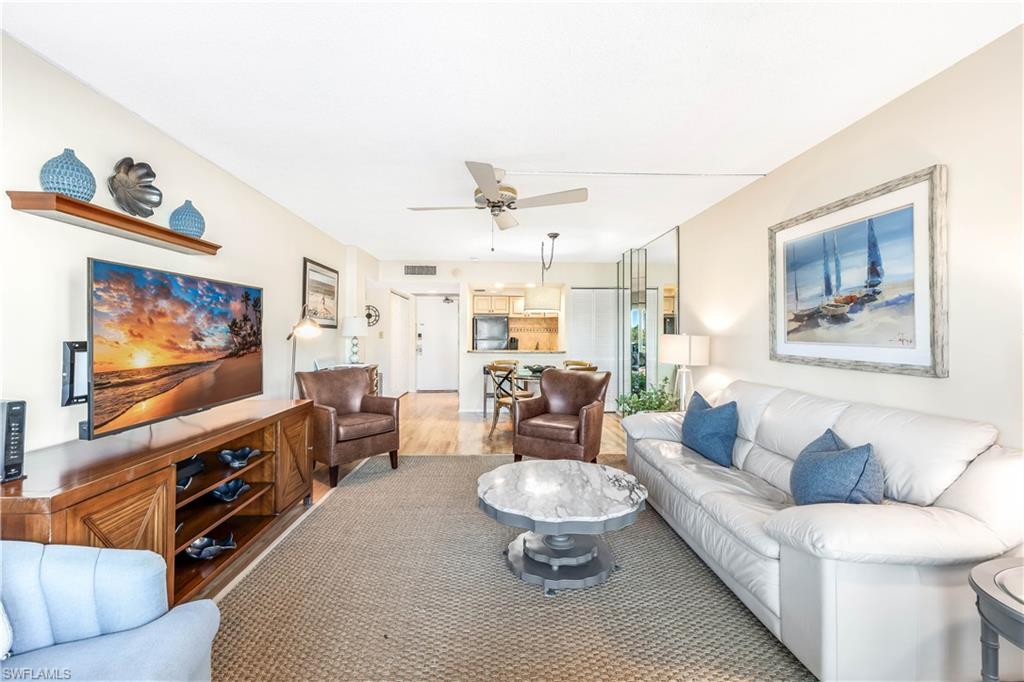 Living room featuring light wood-type flooring and ceiling fan