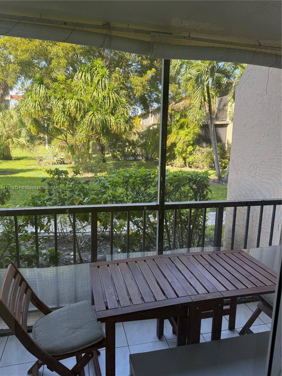 a view of a balcony with table and chairs