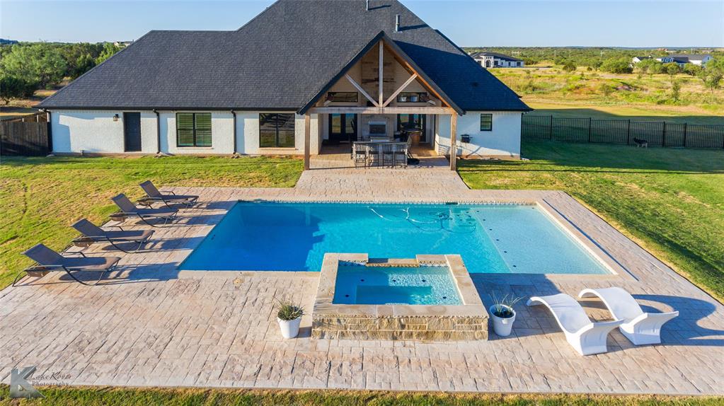 a view of a house with pool and chairs