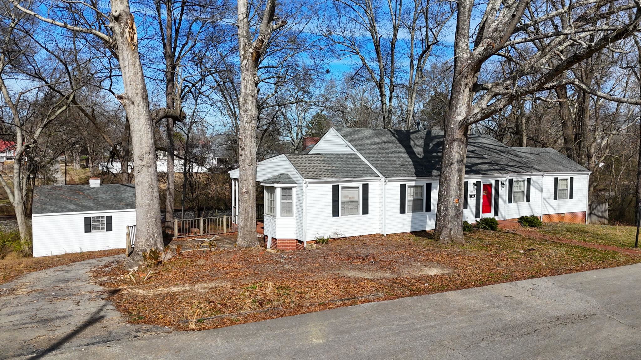 a front view of a house with a yard covered in snow